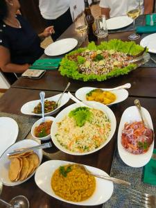 a table with many plates of food on it at Even Beach Oasis in Wayikkal
