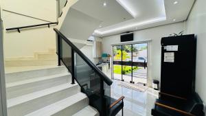 a staircase in a home with a view of the street at Nathus Hotel in Chapadão do Sul