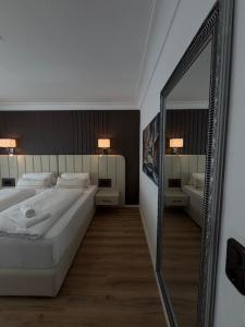 a bedroom with a large mirror and a large bed at FeWo Bispingen in Bispingen