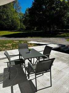 a table and chairs sitting on a patio at Logement Seigneur in Rambervillers +3 photos