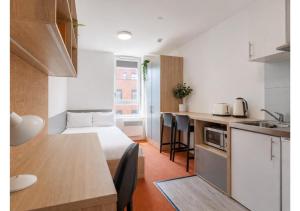 a small apartment with a bed and a kitchen at Globeworks by UTDM in Birmingham