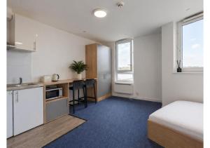 a bedroom with a bed and a kitchen with a desk at Globeworks by UTDM in Birmingham +20 photos