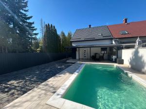 a swimming pool in the backyard of a house at LUX Pool Villa Zamárdi in Zamárdi