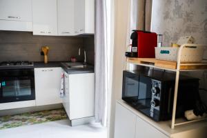 a kitchen with white cabinets and a stove top oven at Casa 1941 in Conversano