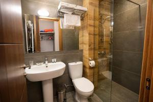 a bathroom with a sink and a toilet and a shower at Hilltop Kazbegi in Kazbegi +64 photos