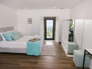 a living room with a bed and a table at Quinta Cerca da Milhera in Ponte da Barca +34 photos