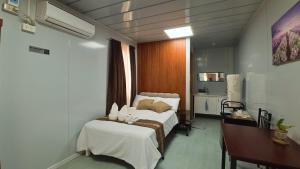 a hotel room with a bed and a desk at Crespina Private House in General Luna