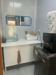 a small kitchen with a sink and a microwave at Crespina Private House in General Luna +68 photos