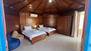 a small bedroom with two beds and a window at Spicy Beach Camp in Nuweiba