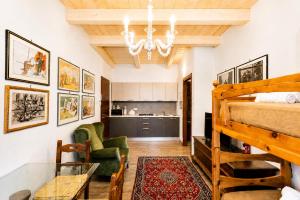 a bedroom with a bunk bed and a living room at Al Battistero Luxury Suite in Ravenna