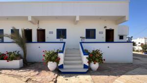 a building with blue and white walls and stairs and flowers at Spicy Beach Camp in Nuweiba