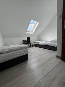 a bedroom with two beds and a window at Air AMBER PEN LOTNISKO parking in Kaszów +15 photos