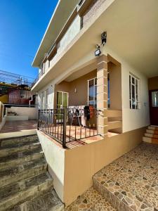 a house with stairs and a fence in front of it at Shalom Villa 2 in Vacoas