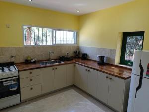 a kitchen with white cabinets and a sink at Finca Magdalena Casa de Campo in San Rafael +19 photos