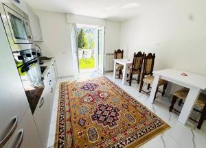 a kitchen with a persian rug on the floor at Villa Amore in Oltre il Colle