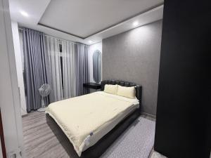 a bedroom with a bed with white sheets and pillows at Sun's house in Phan Rang–Tháp Chàm