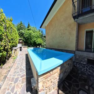a swimming pool in the backyard of a house at Villa Arianna Lake View Apartments with Pool in Tignale