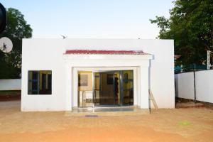 a white building with a door on the side of it at On Edward in Bulawayo