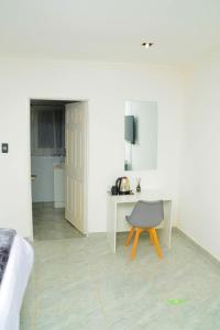 a room with a bed and a desk and a chair at On Edward in Bulawayo