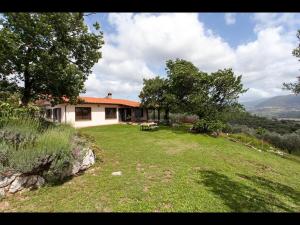 a house on a hill with a grassy yard at B&B da Odila in Poggio Nativo