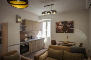 a kitchen with a couch and a table in a room at Island Pearl in Mali Lošinj +17 photos