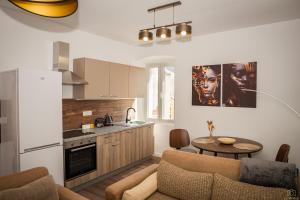 a kitchen and living room with a couch and a table at Island Pearl in Mali Lošinj
