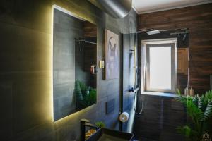 a bathroom with a shower and a sink and a window at Island Pearl in Mali Lošinj