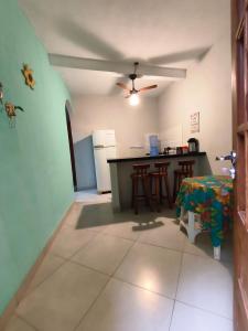 a kitchen with a table and a ceiling fan at Casa da Di in Lençóis