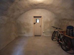 a bike parked in a room with a door at appartamenti Residenza 1928 in Tremosine Sul Garda