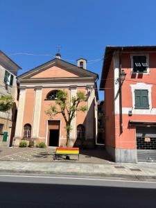 a bench sitting on the sidewalk in front of a building at Casa San Rocco in Busalla