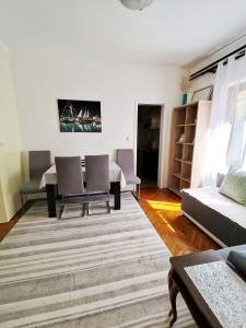 a living room with a table and chairs at Lana 38 in Savina