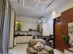 a living room with a couch and a kitchen at Bwera-Comfortable Homes in Kasese