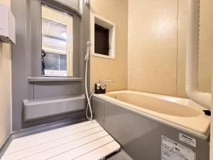 a bathroom with a tub and a window at ura San Jose in Okayama +27 photos