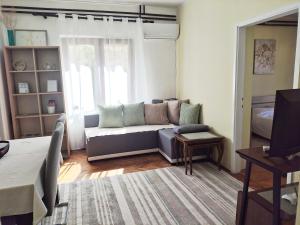 a living room with a couch and a bed at Lana 38 in Savina