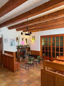 a room with chairs and a bar with a fireplace at Al Montel - Tre faggi in Borgo
