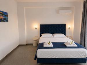 a bedroom with a bed with towels on it at Haraki Emerald in Haraki +12 photos