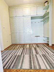 a room with white closet doors and a rug at Lana 38 in Savina +48 photos