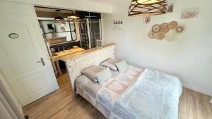 a bedroom with a bed with a vanity and a mirror at Les Pins Perdus in Saint-Ciers-dʼAbzac