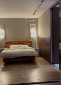 a bedroom with a bed and two lights on the wall at Grape Resort منتجع وشاليهات عنب in Ajloun