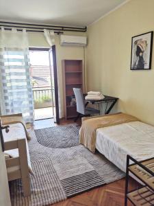 a room with two beds and a desk and a table at Lana 38 in Savina