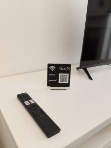 a remote control sitting on a counter next to a box at Royal Nest Venaria Reale in Venaria Reale