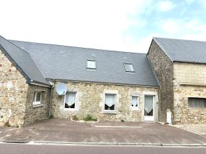 a large stone building with a lot of windows at Chambre du Cotentin in Créances