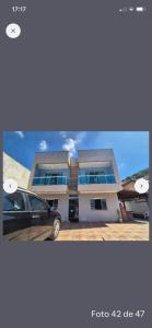 a car parked in front of a house at Apartamento 2 Vargem Grande RJ in Rio de Janeiro