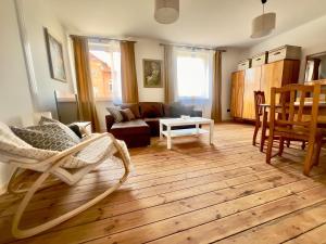 a living room with a couch and a table at Apartament Świętojański in Tolkmicko