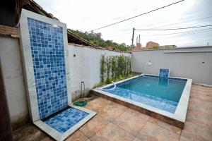 a swimming pool in the backyard of a house at Apartamento 2 Vargem Grande RJ in Rio de Janeiro