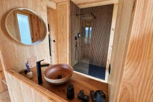 a wooden bathroom with a wooden toilet in a room at Cabanas do Navia in Coea +48 photos