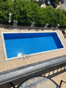 a swimming pool with a pair of glasses on top of it at Apart Capital FISA Kamenari in Kamenari