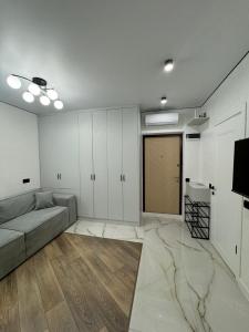 a living room with a couch and a television at ЖК Акварель 8 in Odesa