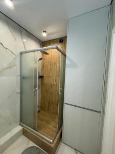a shower with a glass door in a bathroom at ЖК Акварель 8 in Odesa
