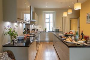a kitchen with a long counter with food on it at The Clarence in Bishop Auckland